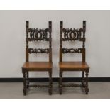 A pair of French provincial mahogany hall chairs, finely carved backs, raised on turned supports