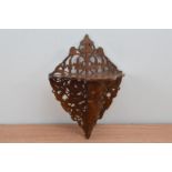 A late 19th century mahogany fretwork wall stand, fretwork back, shaped shelf 33cm high