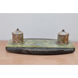 An art deco desk tidy, with two metal inkwells, on a marble and stone rounded rectangular base 34.