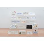 A collection of British ceramic advertising plaques, including Spode, Royal Albert, Rye Pottery,