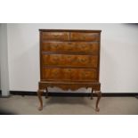 A Georgian and later walnut and mahogany chest of drawers on stand, two short drawers over three