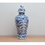 An early 20th century Chinese blue and white porcelain vase and cover, floral and scrolling