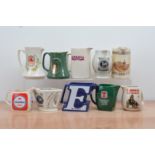 A collection of ten ceramic beer branded water jugs, including Jubilee Stout, Tennents, Guinness,