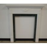 A 20th century fire-surround, in the Georgian style, wooden frame and painted white, with green