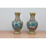 A pair of early 20th century Japanese decorative enamel and metal baluster vases, both depicting