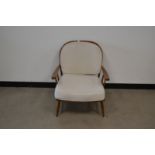 A 1960's 'G-Plan' style armchair, with cream removable cushions (stained) 78cm H x 66cm W