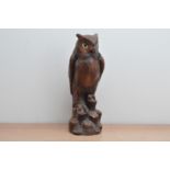 A large resin owl, with some damage, one claw absent, 37.5cm high