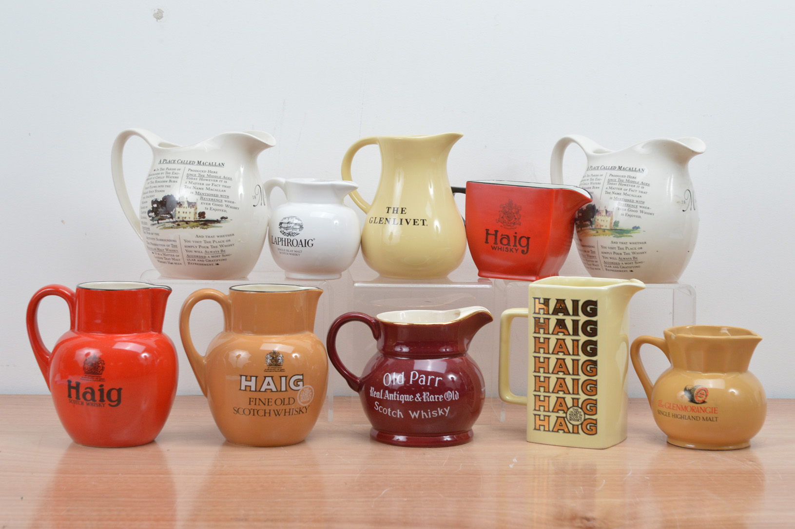 A collection of ten whiskey ceramic branded water jugs, including Haig, the MaCallen, Old Parr, etc,