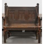 A 19th century and later carved oak settle/bench, three carved panel back with carved seat and