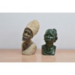 Two carved hardstone busts of African women, of differing heights and styles, the tallest 22cm