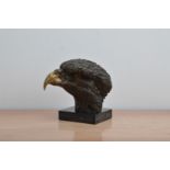 A 20th century bronze bust of an eagles head, unmarked on a square marble base, 19cm high