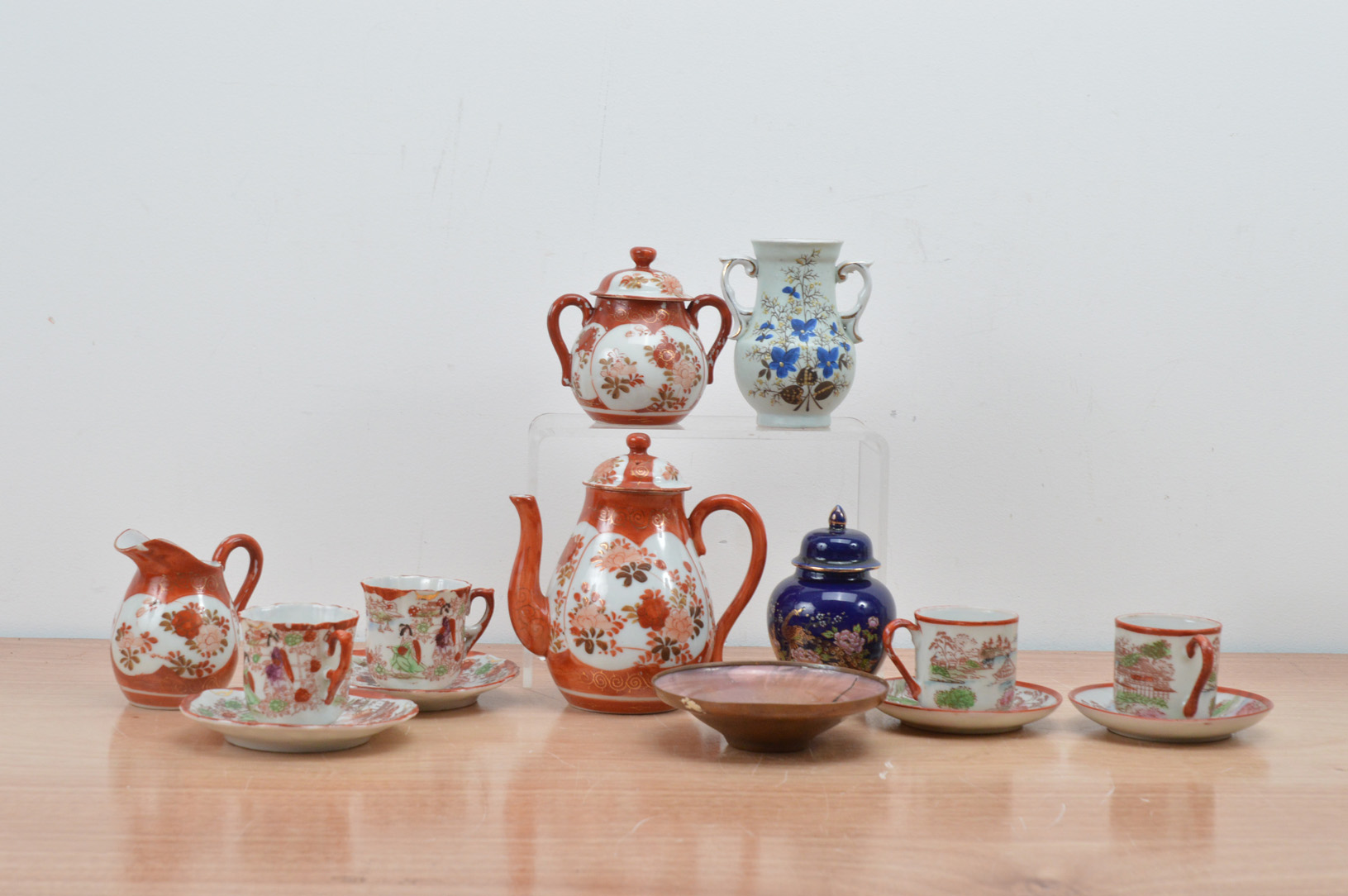 A collection of Japanese export porcelain items, comprising a tea set, vases and a small jar with