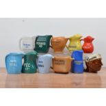A collection of eleven ceramic continental water jugs, including Pernod, Berger Pastis, etc, of