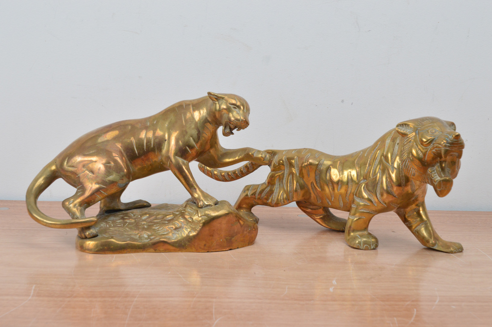 Two brass 20th century Far Eastern animals, comprising a tiger and lioness 36cm x 30cm (2)