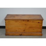 A turn of the century pitch pine chest, cast metal carrying handles, the lock broken and parts