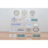 A collection of British ceramic advertising plaques, including Spode, Minton, Coalport, Poole