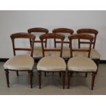 A set of six Victorian mahogany framed dinning room chairs, carved backs on turned and fluted