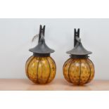 Two 20th century hanging garden lanterns, metal bracket with yellow/orange glass AF 28cm high (2)