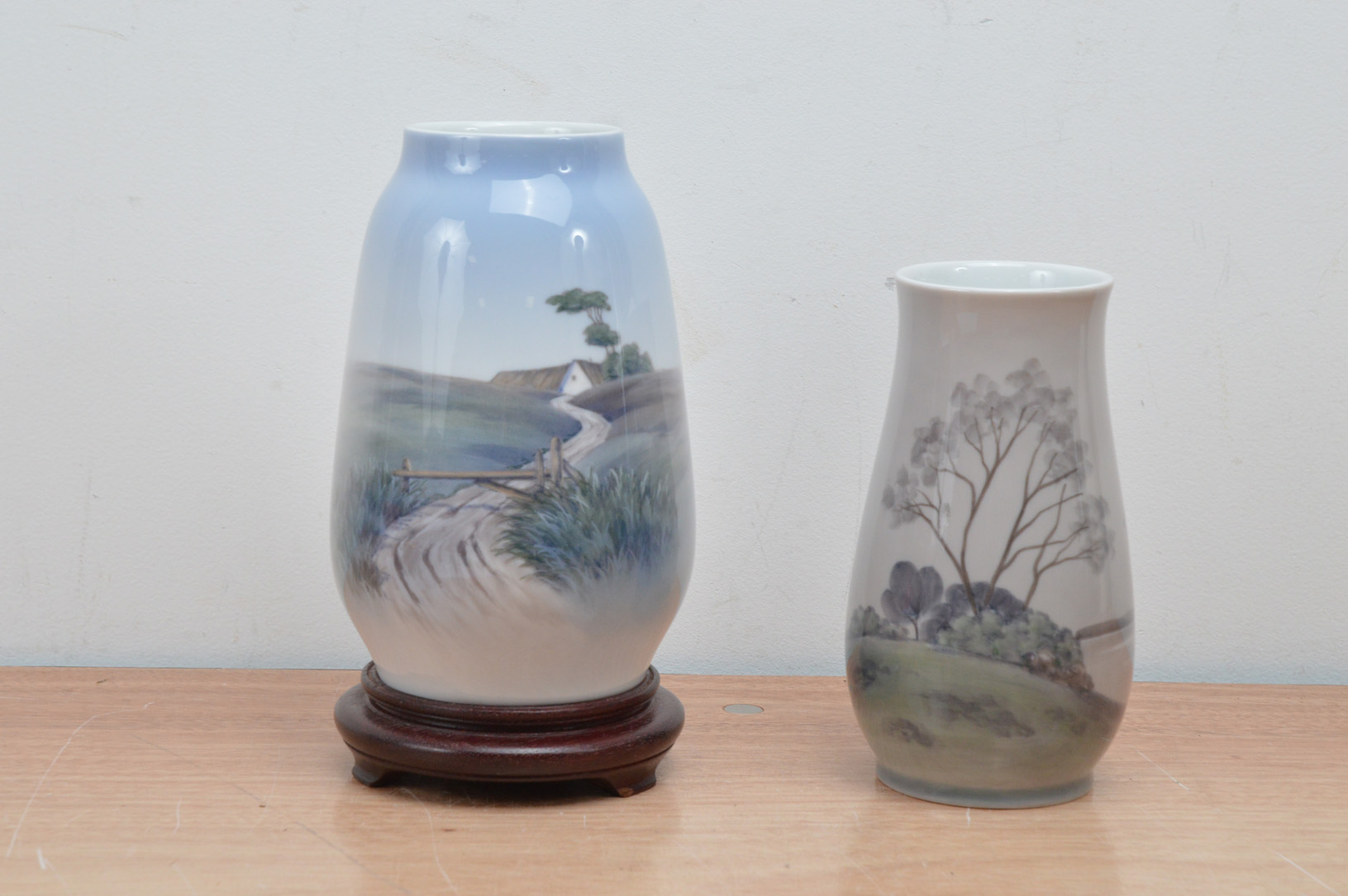 One Royal Copenhagen porcelain vase, the other B&G, of differing sizes, with landscape scenes, one