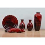 A collection of Royal Doulton Flambe ceramics, comprising a prone fox 34cm in length, a tall vase