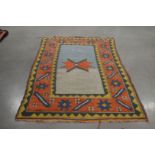 A 20th century Caucasian woollen rug, multi coloured design, with some wear, 132cm x 209cm