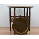 A 20th century Middle Eastern brass tray and stand, foldable stand, 56cm H x58cm diameter,