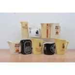 A collection of nine ceramic Whiskey branded water jugs, comprising four Whyte & Mackay, two Black &