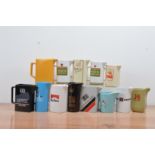 A collection of 13 cigarette branded ceramic water jugs, including Marlboro, Silk Cut, Hamlet,