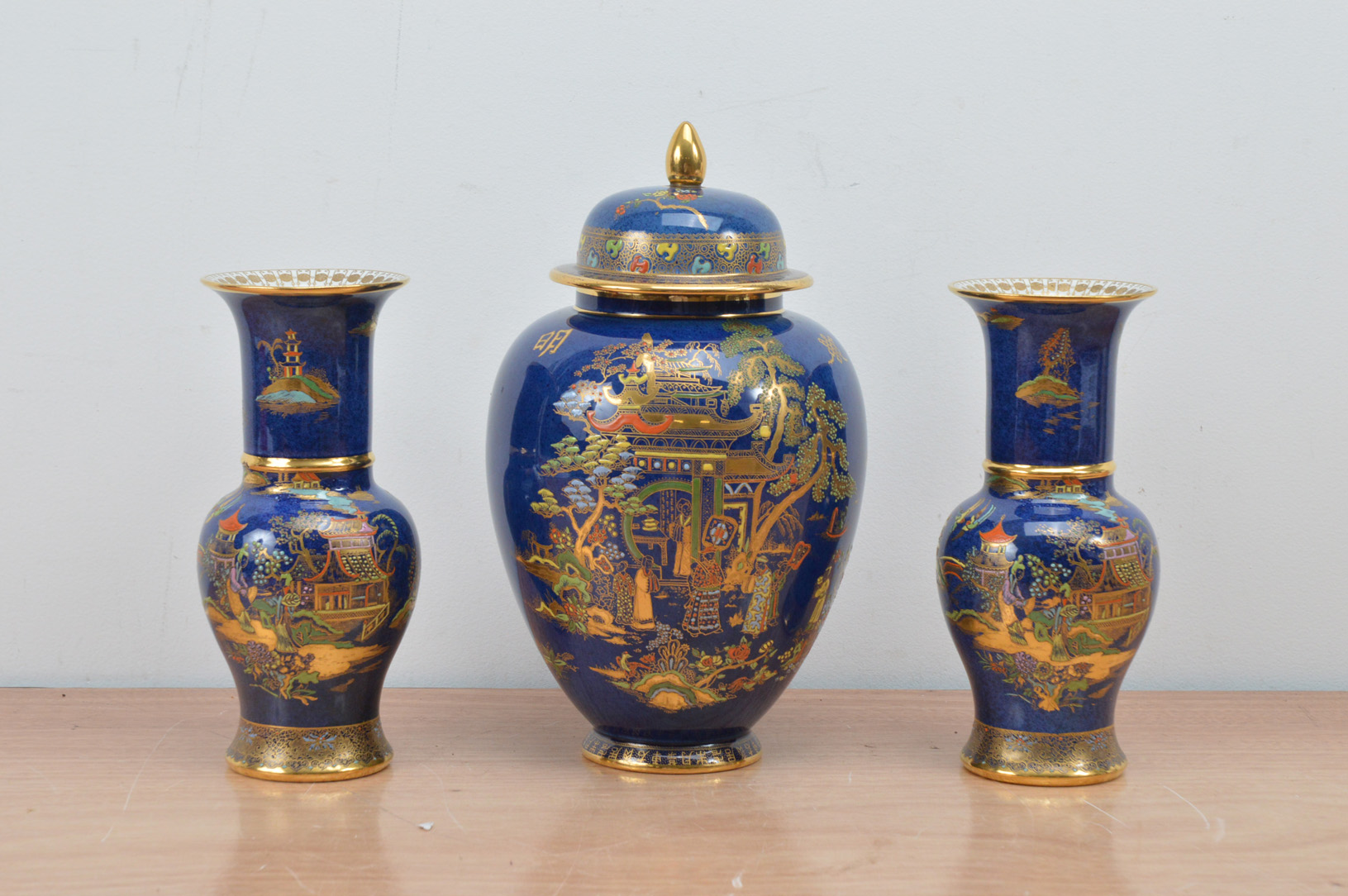 Three items of 20th century Chinoiserie Carltone Ware, heightened gilt on a blue ground,