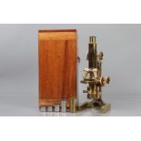 A late 19th Century/early 20th Century lacquered brass Ross Compound Monocular Microscope, serial