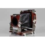 An Ebony SV45 Ti 4 x 5in Plate Camera, mahogany with titanium binding, with pan and tilt, rise and