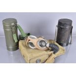 A WWII gas mask, dated 1943, within a 1945 military issue carrier, plus two metal gas mask