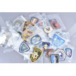 An assortment of World Police badges, to include French, American, Interpol, Australian, Pacific Air