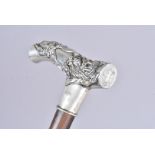 An Oriental-style white metal topped walking cane, with embossed dragon design, with applied