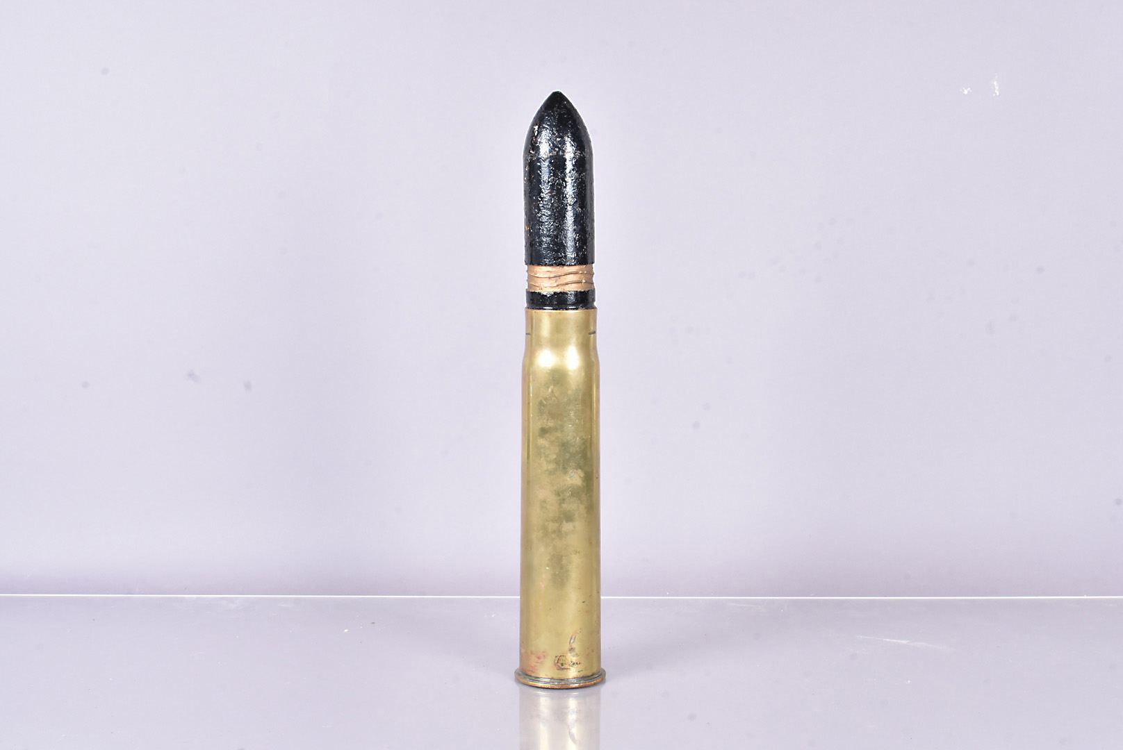 A large inert military shell, 48cm tall, 7.5cm diameter at base