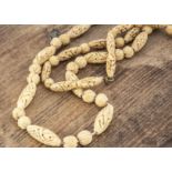 A prisoner of war carved bone bead necklace, with oval and spherical beads, 50cm together