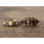 A Edwardian 9ct gold opal and diamond ring, the domed cabochon opals set with pairs of diamond