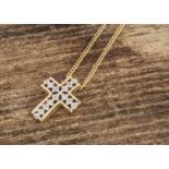 A 14k marked yellow and white metal and diamond cross pendant, on a flattened 18ct gold necklace,