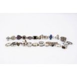 A collection of silver dress rings, some set with gem stones, others of plain form, textured