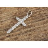 An 18ct gold diamond cross pendant, the brilliant cuts in claw settings, 2.5 cm by 1 cm, 0,28cts 1.
