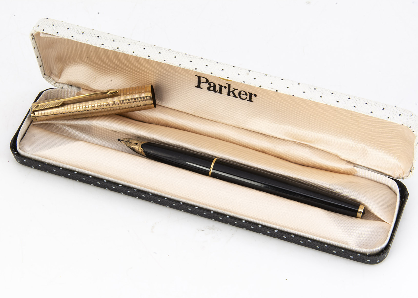 A c1960s Parker fountain pen, rolled gold cap with black barrel and 14ct gold nib, in a Parker