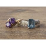 Two gem set rings, a cross over example set with synthetic colour change corundum size L, and a