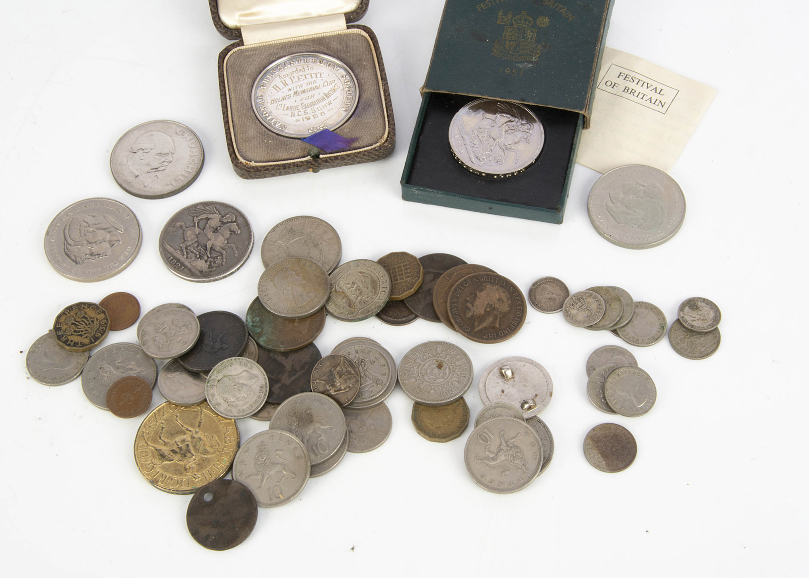 A small collection of coins and more, including an 1821 crown, an 1806 half penny, and more, also
