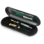 A modern Pelikan fountain pen, in box, with green striped barrel and black cap, 14ct gold nib, not