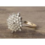A diamond set cluster ring in 9ct gold, hexagonal setting, set with eight cuts, ring size P, 3.6