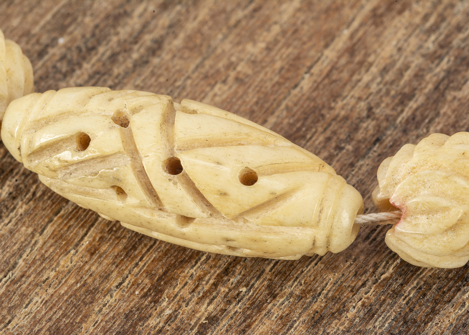 A prisoner of war carved bone bead necklace, with oval and spherical beads, 50cm together - Image 2 of 2