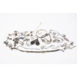 A collection of silver earrings and other silver jewellery, including a butterfly enamel necklace, a