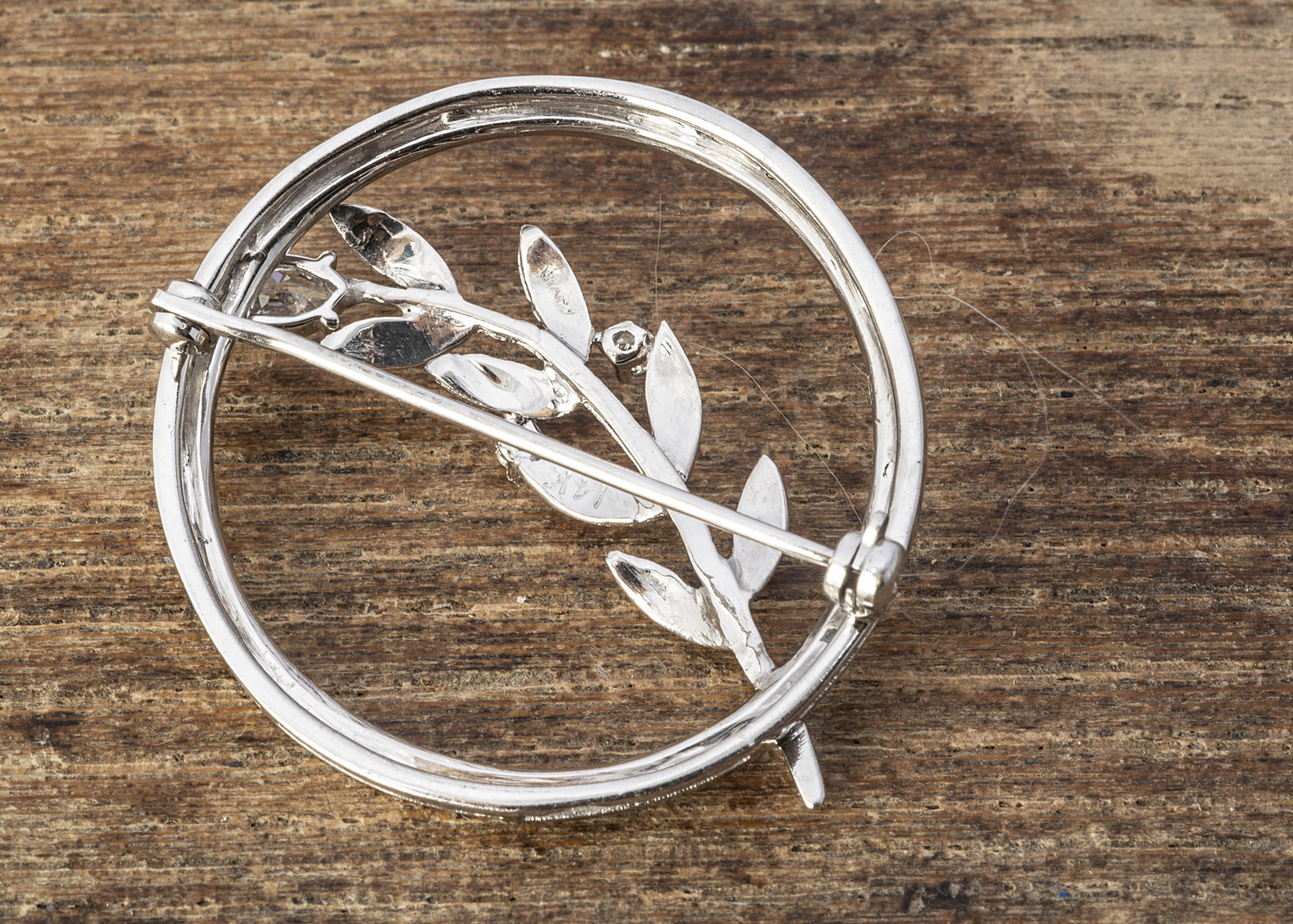 A continental white metal 14K marked circular brooch, of open worked leaf design, with white CZ - Image 2 of 2