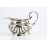 A late Victorian silver milk jug by William Hutton & Sons, 5.5 ozt, London 1897