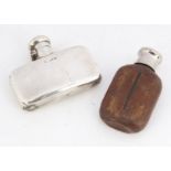 A late Victorian small silver hipflask, 2 ozt, 8.5cm wide, some dents, together with a small glass